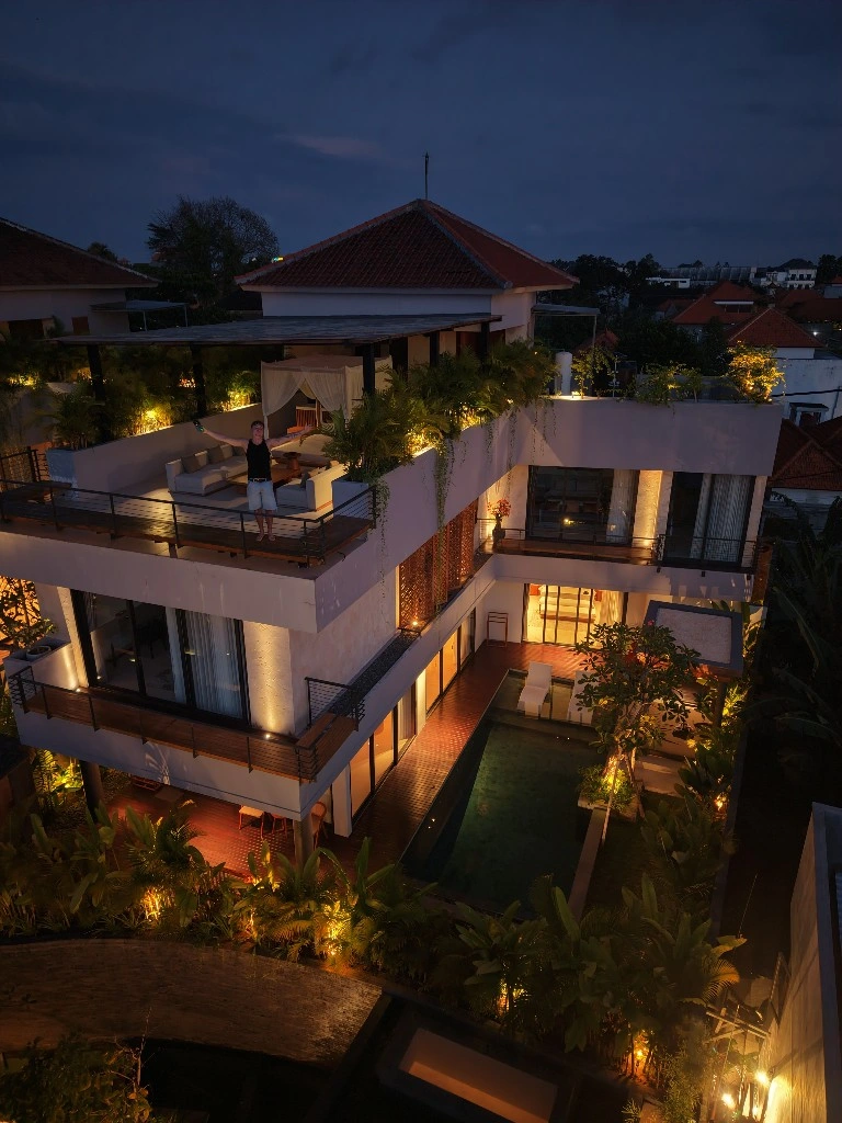 Lukas on a rooftop terrace at a luxury villa at dusk